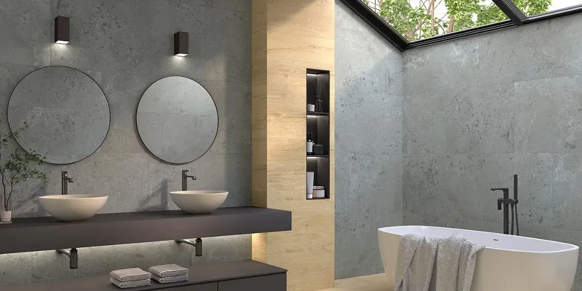 Un baño moderno con dos lavabos, espejos y una bañera bajo una claraboya.