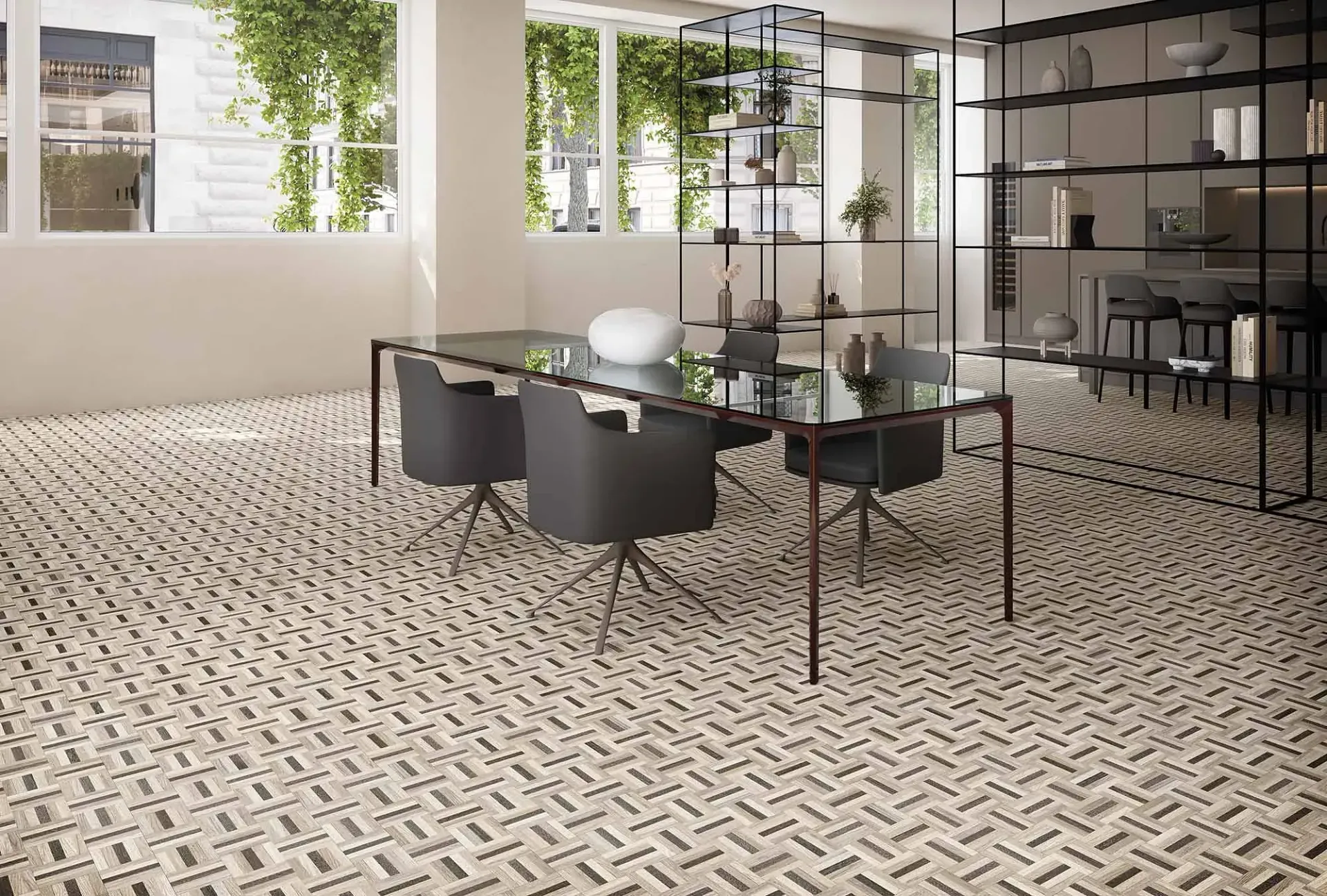 Sala de reuniones con suelo estampado, mesa y sillas. Estanterías con objetos decorativos y una ventana con plantas.