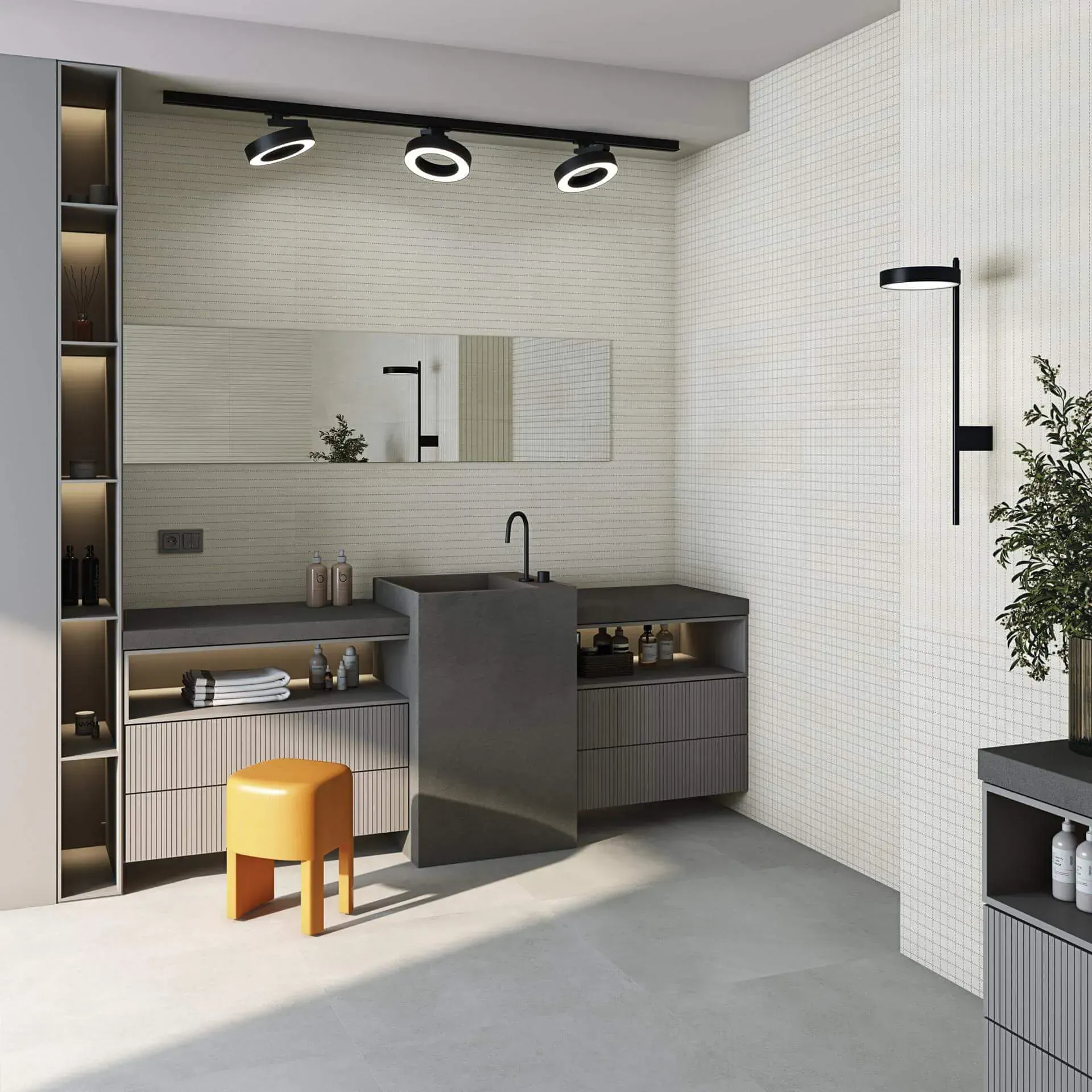 Baño moderno con azulejos grises y blancos, tocador oscuro, taburete naranja y planta.
