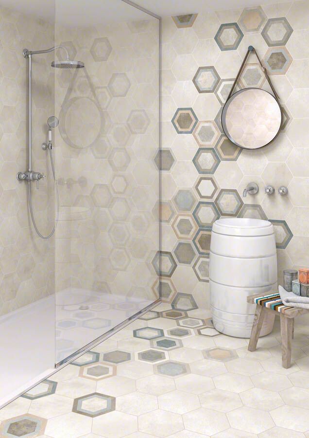 Baño con diseño de azulejos en panal; ducha, lavabo, espejo y taburete. Colores: beige, gris y marrón.