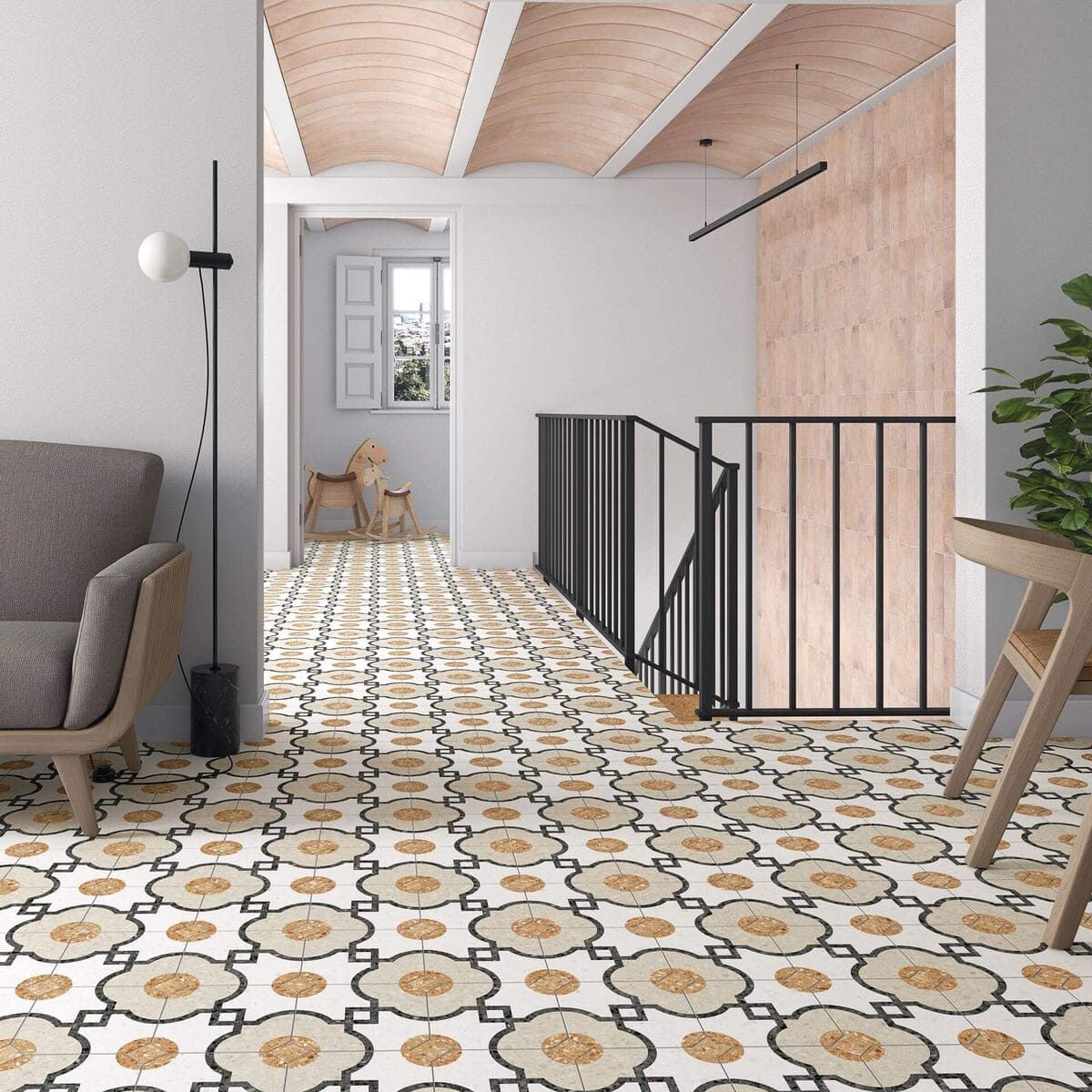 Pasillo con suelo de baldosas estampadas, escaleras, techo abovedado, sillón y planta.