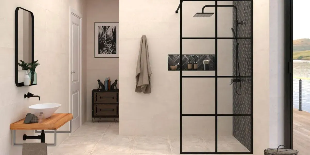 Baño con tocador de madera, espejo con marco negro y ducha con paneles de rejilla negros.