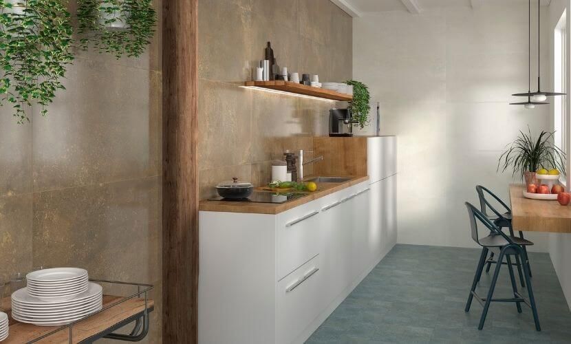 Cocina moderna con gabinetes blancos, detalles de madera y pisos color verde azulado.