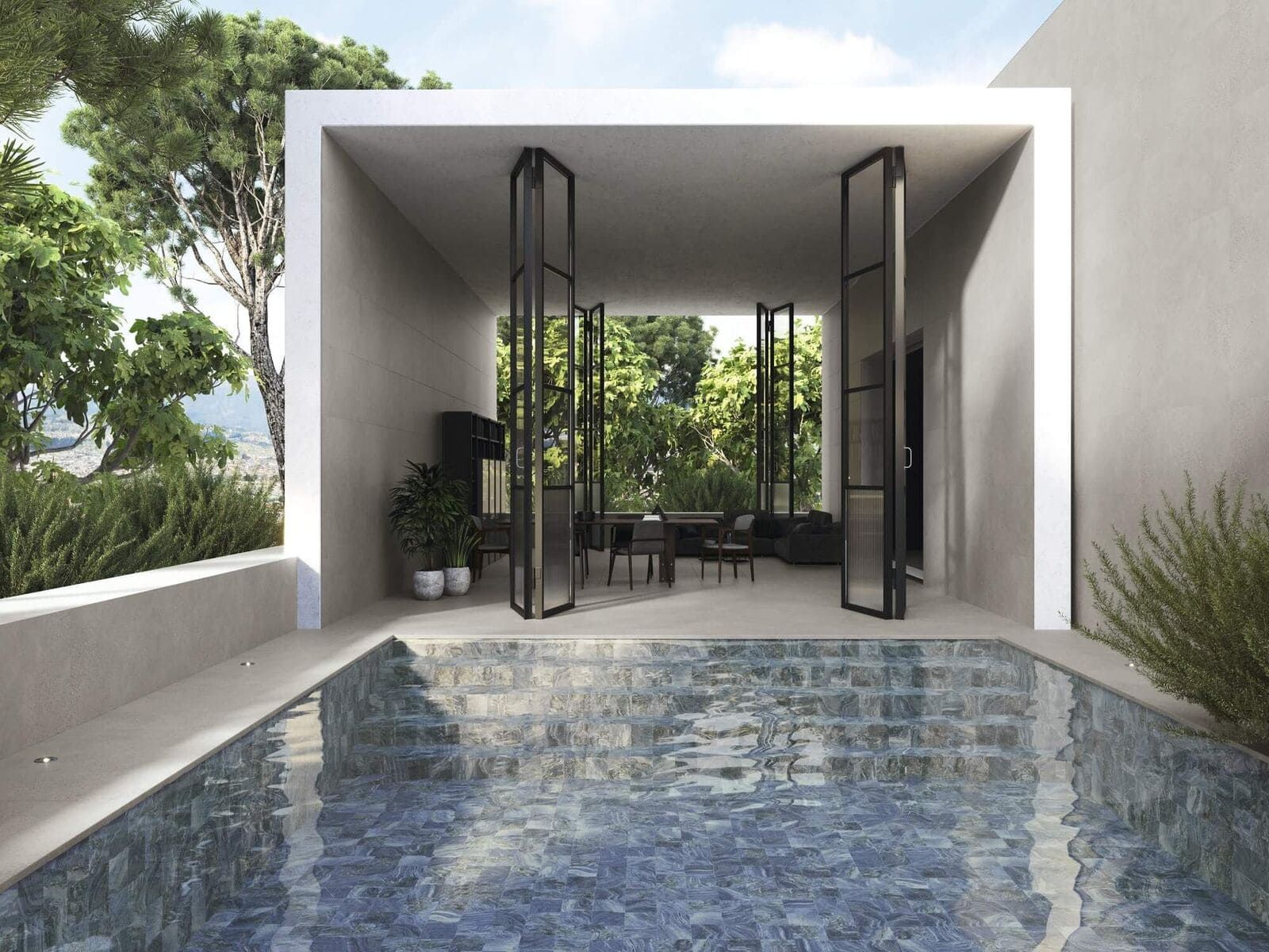 Espacio junto a la piscina con puertas de cristal que dan a un comedor. La piscina tiene mosaicos azules.