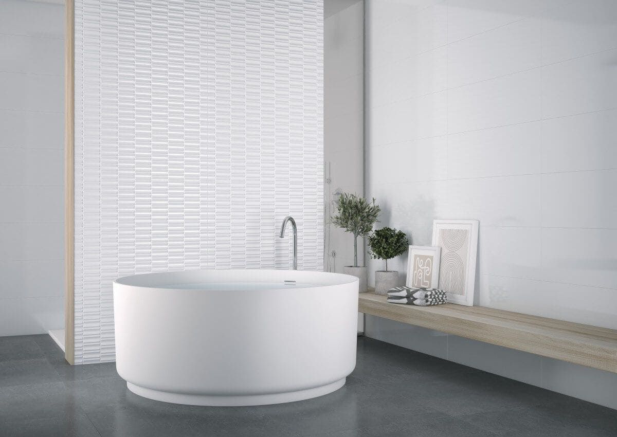 Bañera blanca en un baño moderno con pared de azulejos blancos texturizados y estante de madera con plantas.