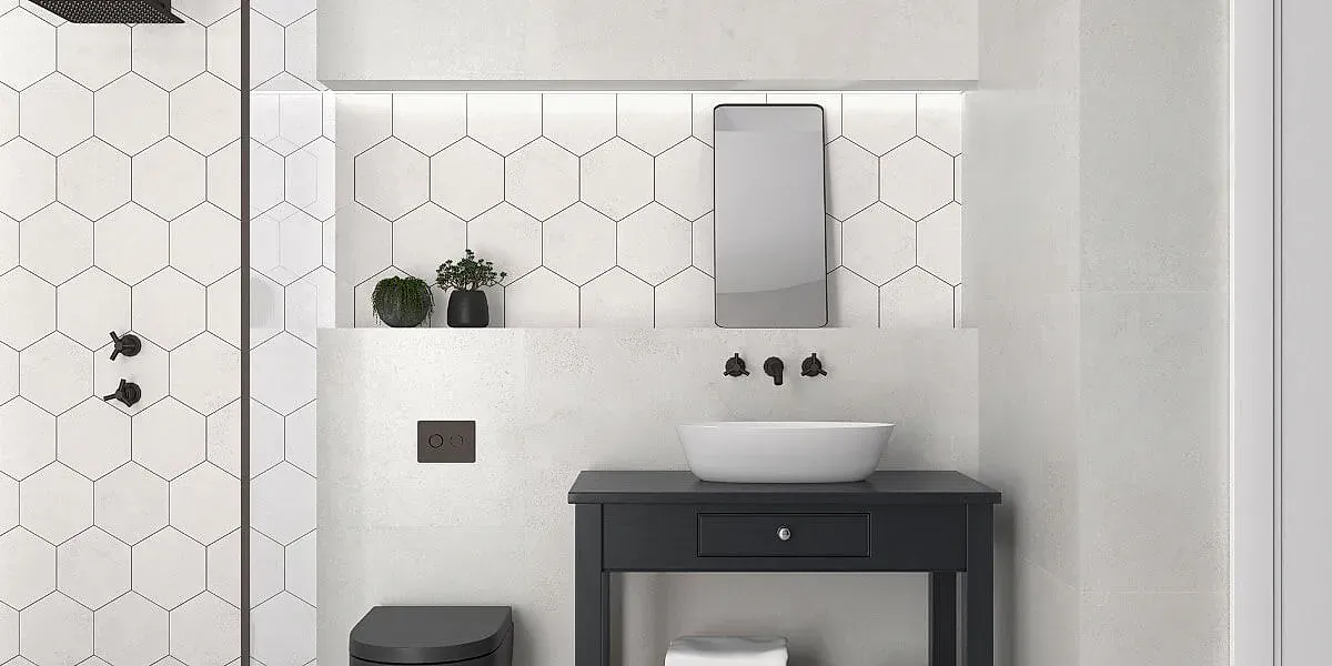 Baño moderno con azulejos hexagonales blancos, tocador negro y lavabo tipo vasija.