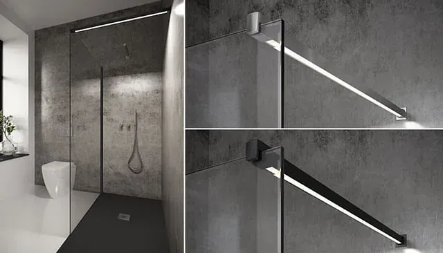 Baño moderno con mampara de ducha de cristal, paredes de hormigón gris oscuro e iluminación lineal.