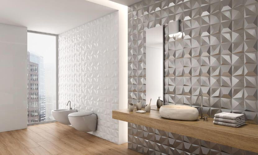 Baño moderno con azulejos de pared geométricos, tocador de madera y ventanal.