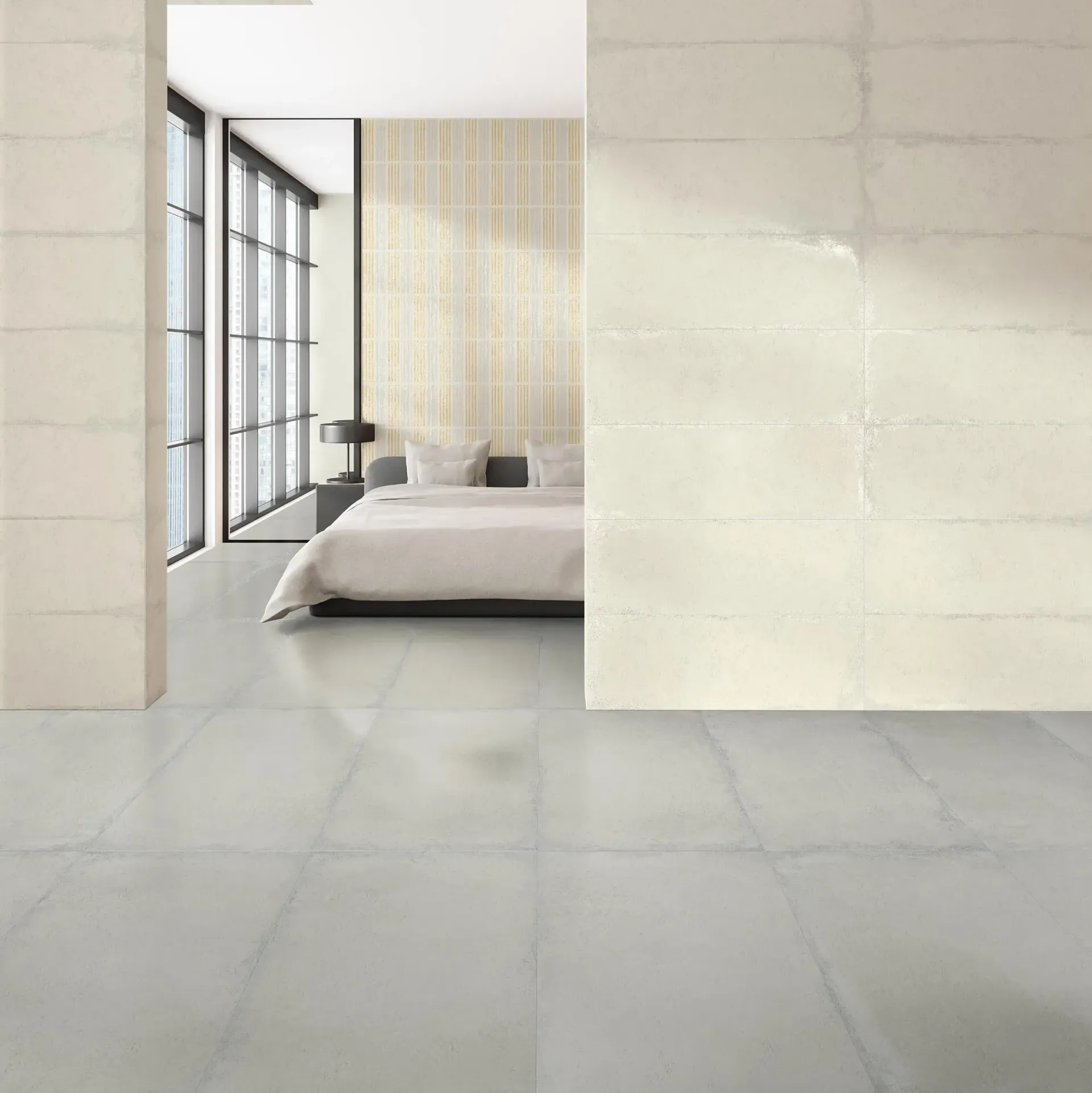 Dormitorio moderno con suelo de baldosas gris claro, cama y pared con detalles de azulejos. Grandes ventanales a la izquierda.