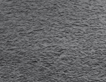 Superficie gris texturizada, posiblemente piedra o material rugoso.