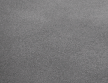 Superficie gris texturizada, posiblemente piedra o material rugoso.