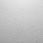 Superficie gris texturizada, posiblemente piedra o material rugoso.