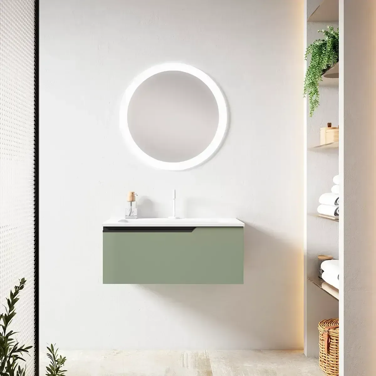 Baño moderno con tocador flotante verde, espejo redondo iluminado y estanterías.