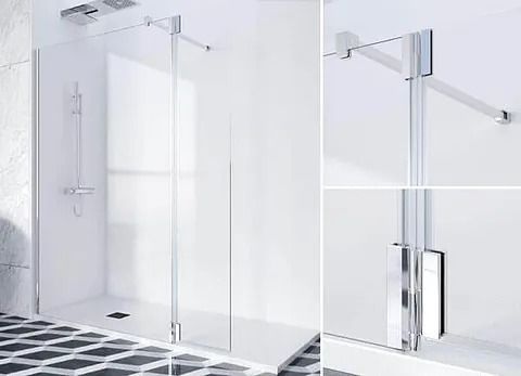 Mampara de ducha de cristal con herrajes cromados, paredes y suelo en color blanco con azulejos en blanco y negro.