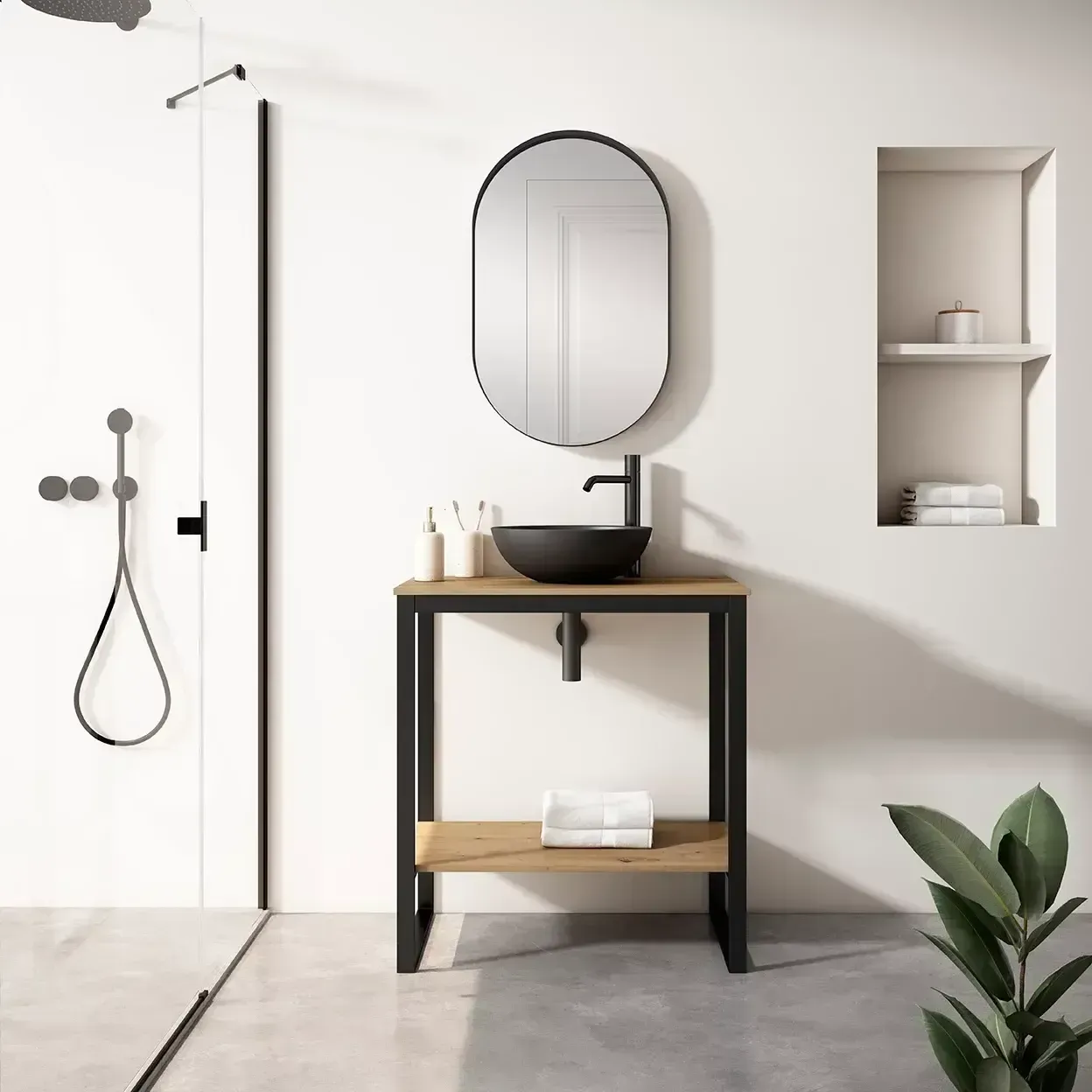 Baño con tocador negro y madera, espejo ovalado, ducha y una pequeña estantería empotrada.