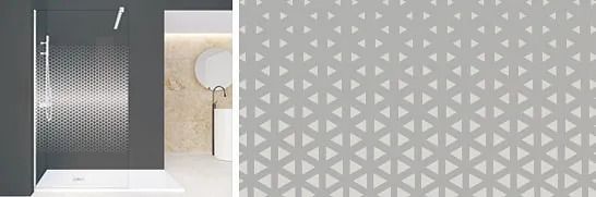 Baño con pared de ducha con patrón geométrico gris.