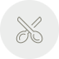 Icono de tijeras, cruzadas, en un círculo gris.