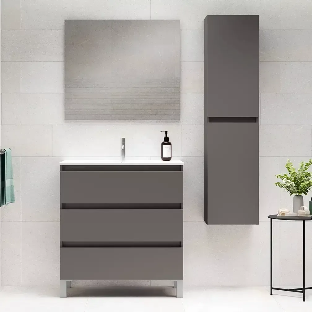 Mueble de baño gris con cajones, espejo, mueble alto y mesa pequeña.