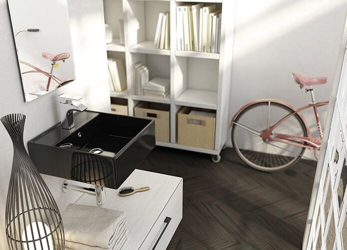 Baño con lavabo negro, almacenamiento blanco y una bicicleta rosa sobre un piso de madera oscura.