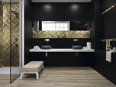 Baño moderno en negro y dorado con ducha de mosaico, lavabos dobles y un banco.