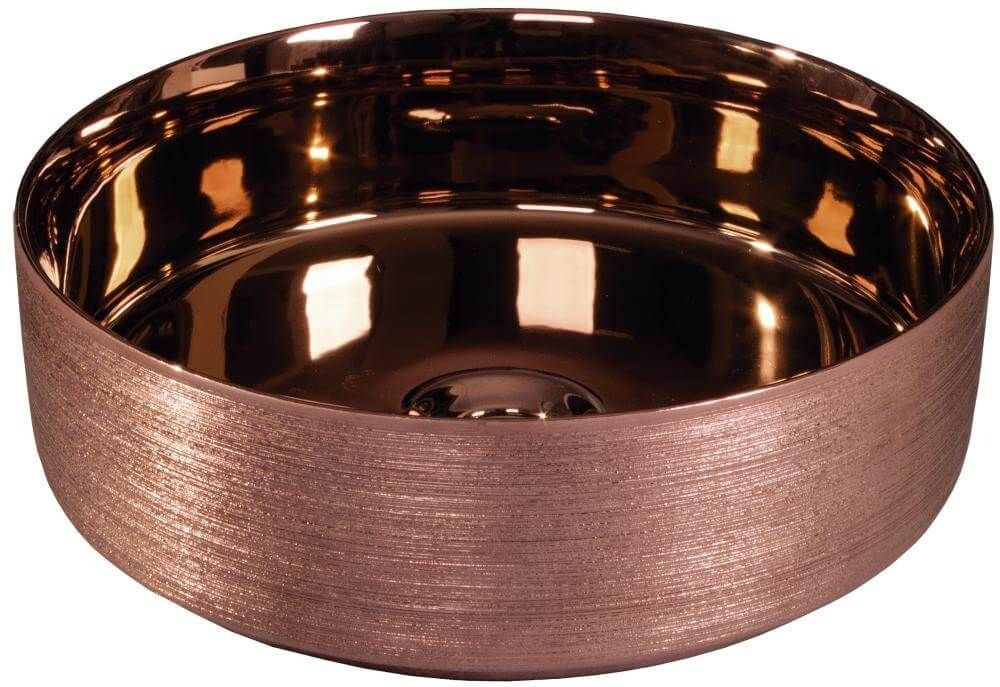 Lavabo de baño circular de color bronce con exterior texturizado e interior liso y reflectante.