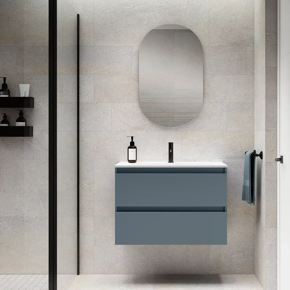 Tocador de baño azul con cajones, espejo ovalado y detalles en negro en un baño moderno.