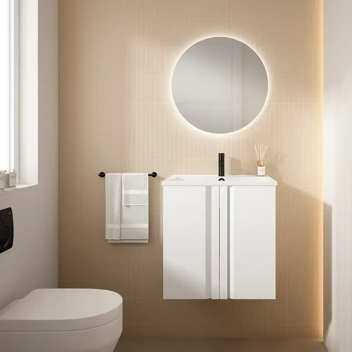 Baño moderno con tocador blanco, espejo redondo con luz LED e inodoro.