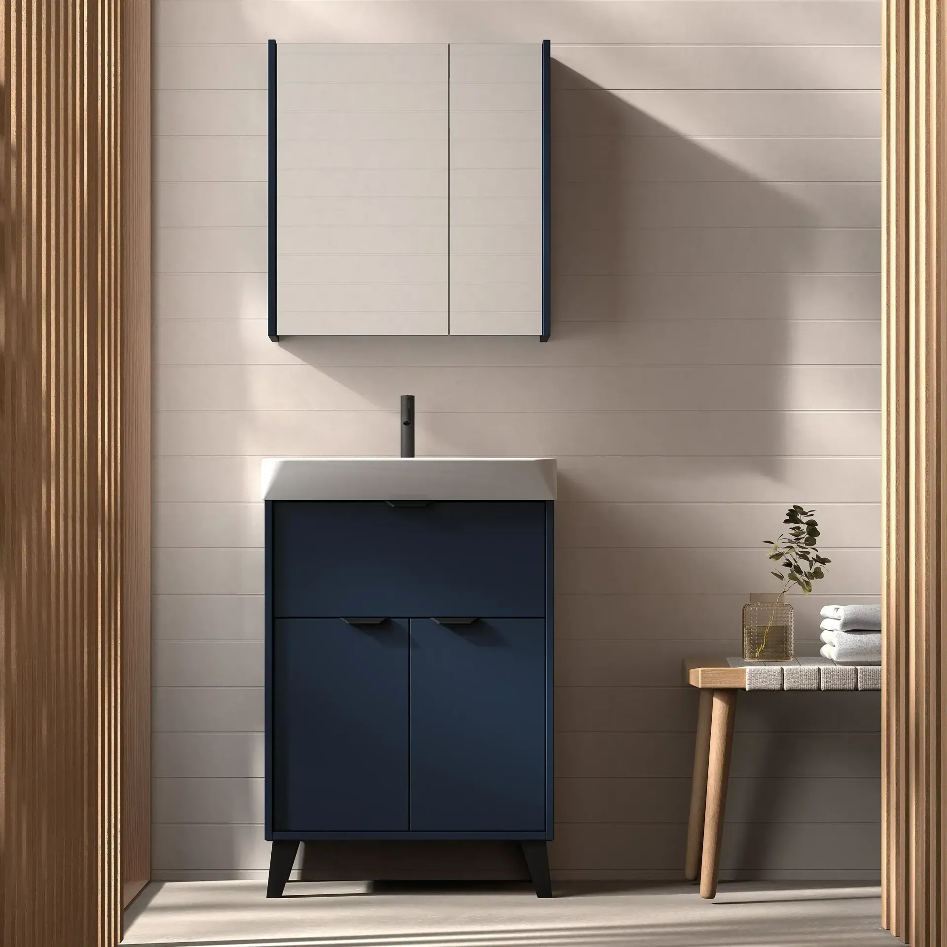 Tocador azul con mueble a juego en un baño moderno.