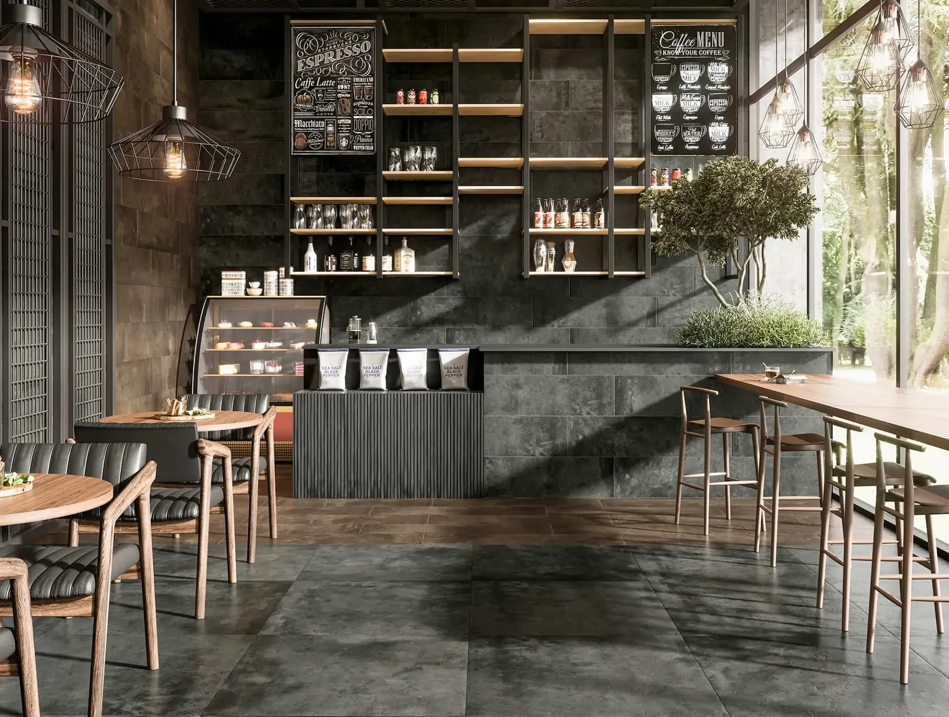 Interior de cafetería con paredes de color gris oscuro, estantes llenos de suministros y mesas y sillas de madera.