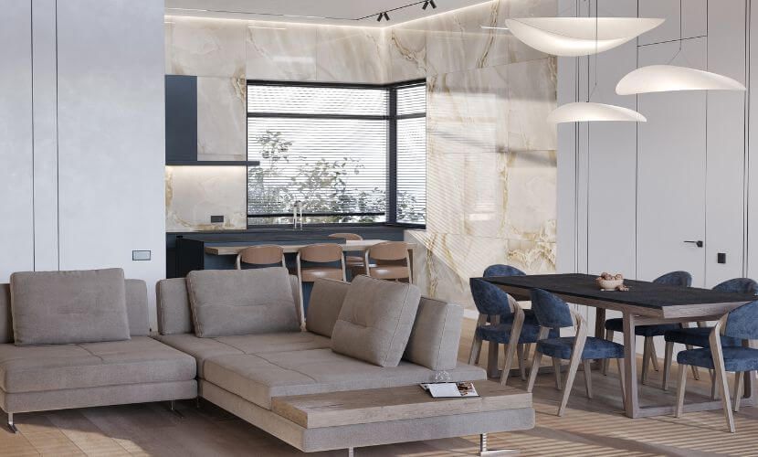 Espacio habitable moderno de planta abierta: cocina, comedor y sala de estar con detalles en beige y azul.
