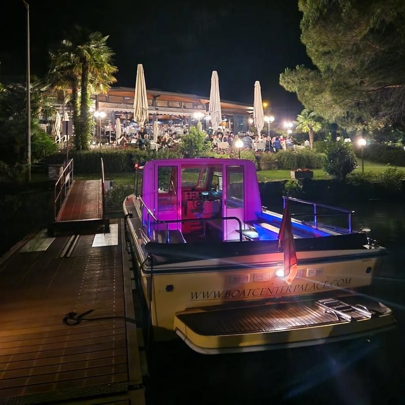 Una barca con la cima viola è attraccata di notte