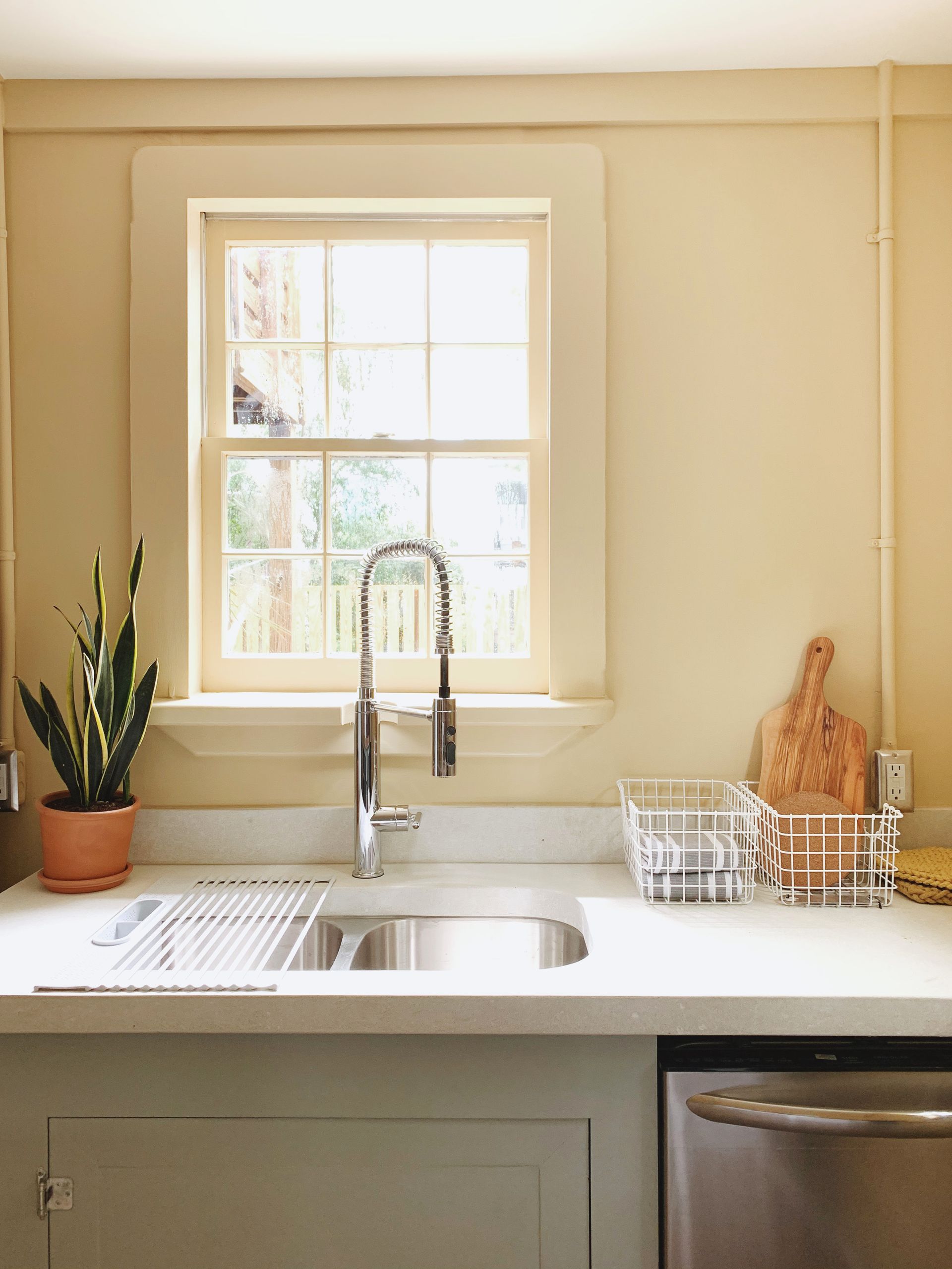 A kitchen counter with a sink and a window