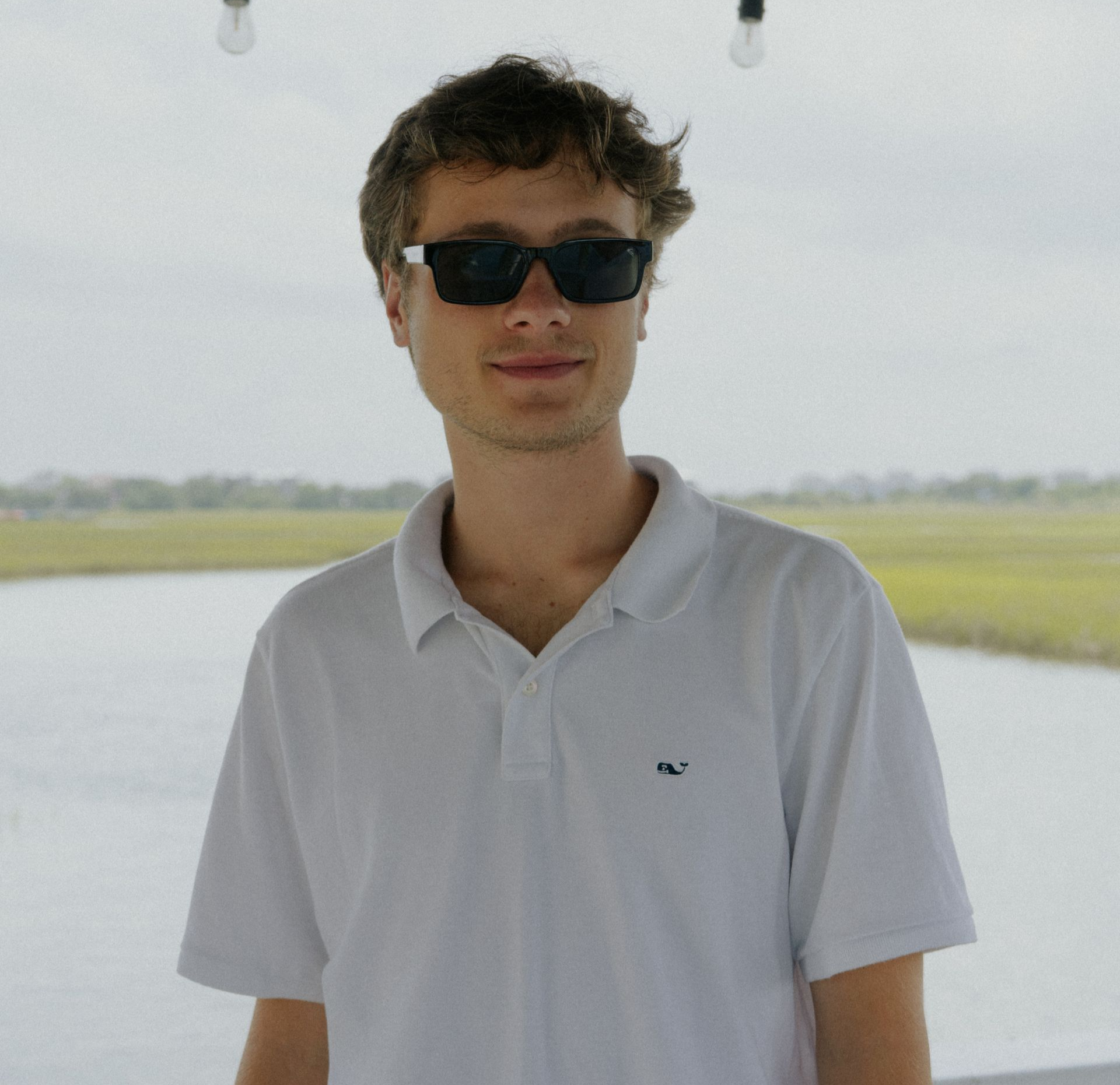 A man in a brown shirt is sitting on a couch