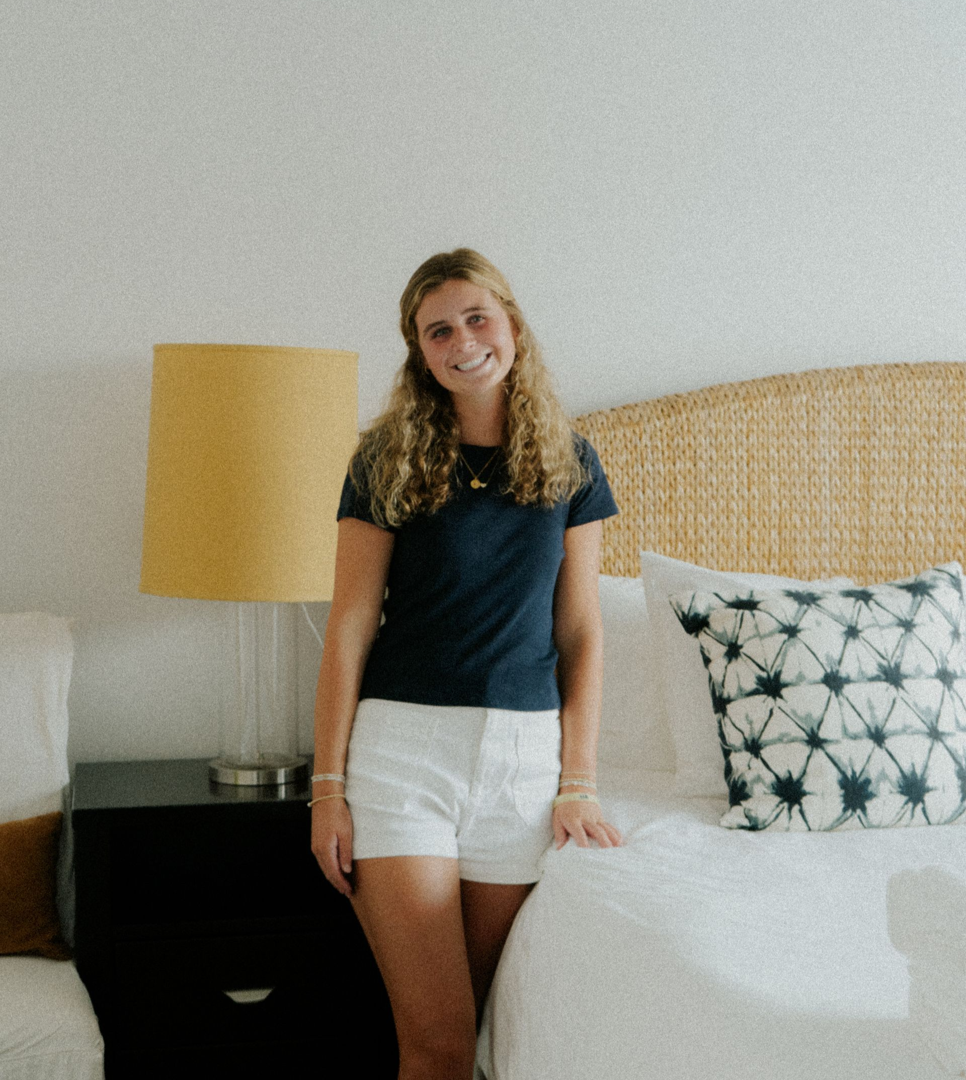 A man in a brown shirt is sitting on a couch