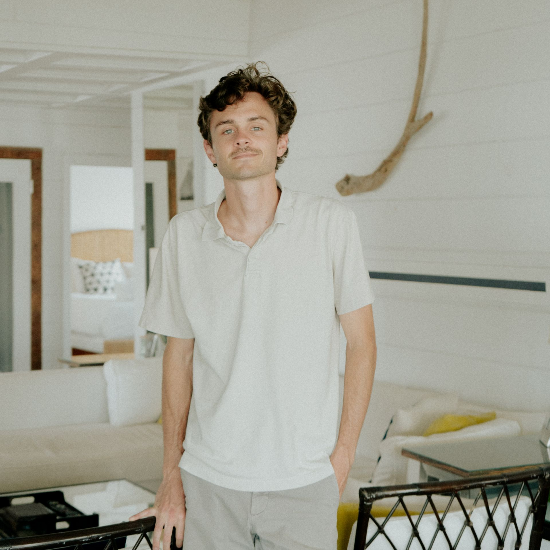 A man in a brown shirt is sitting on a couch
