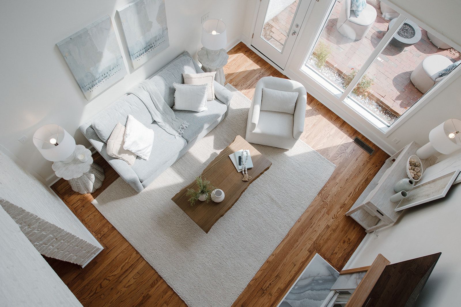 An aerial view of a living room with a couch , chairs and a coffee table.