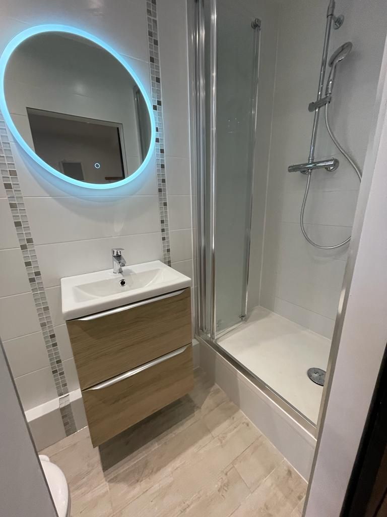 Salle de bain avec miroir rond lumineux