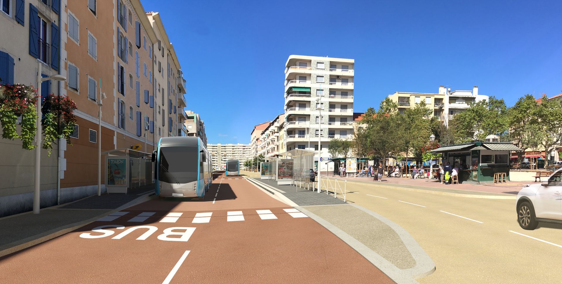 Rue de la ville avec un tramway sur une voie de bus rouge, des immeubles d'habitation et un passage piéton.