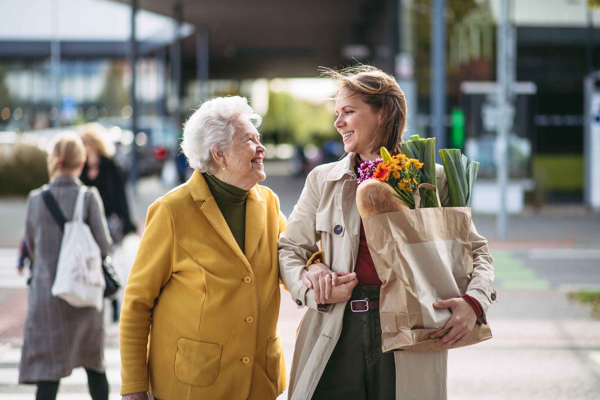 Une femme qui porte un sac de courses et une femme âgée