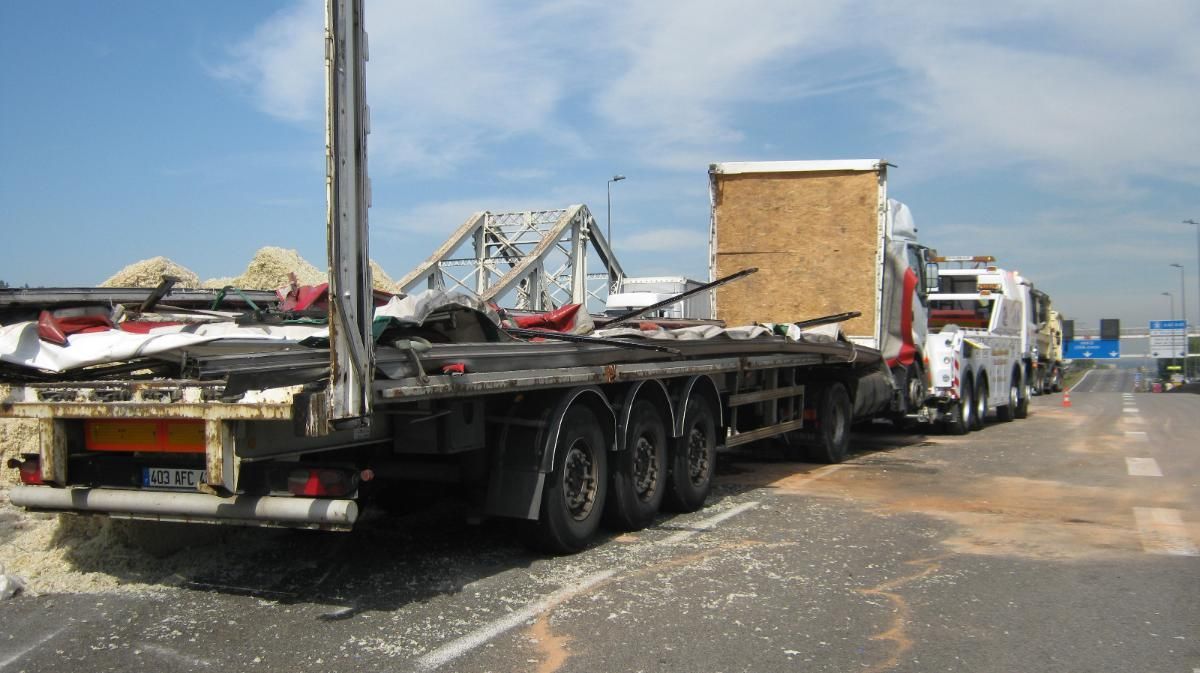 Plusieurs dépanneuses blanches stationnées devant un bâtiment.