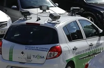 White car with multiple cameras on its roof, labeled
