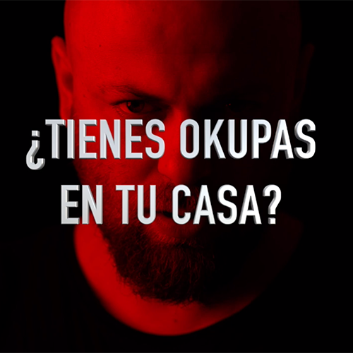 A bald man with a beard and the words tienes okupas en tu casa