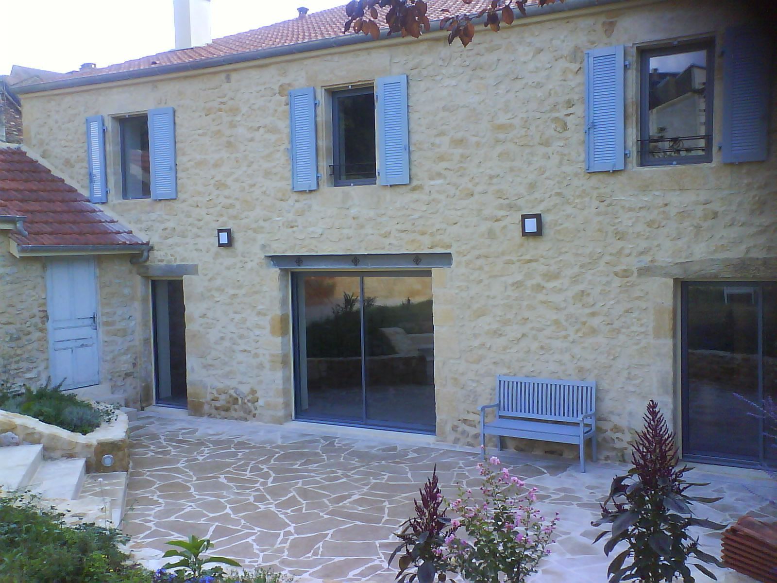 Terrasse en pierre devant maison rénovée