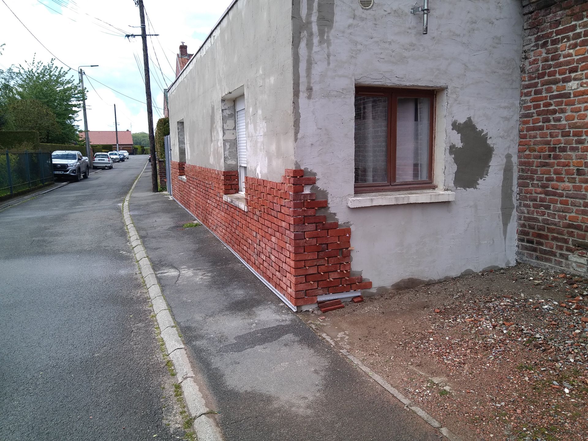 ravalement de façade en cours avec des briques rogues