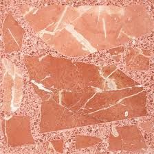 Un primer plano de un azulejo rojo con textura de mármol.