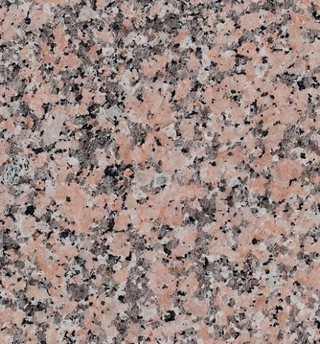 Un primer plano de una encimera de granito rosa.