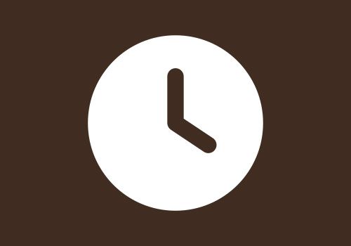 Eine weiße Uhr in einem Kreis auf braunem Hintergrund