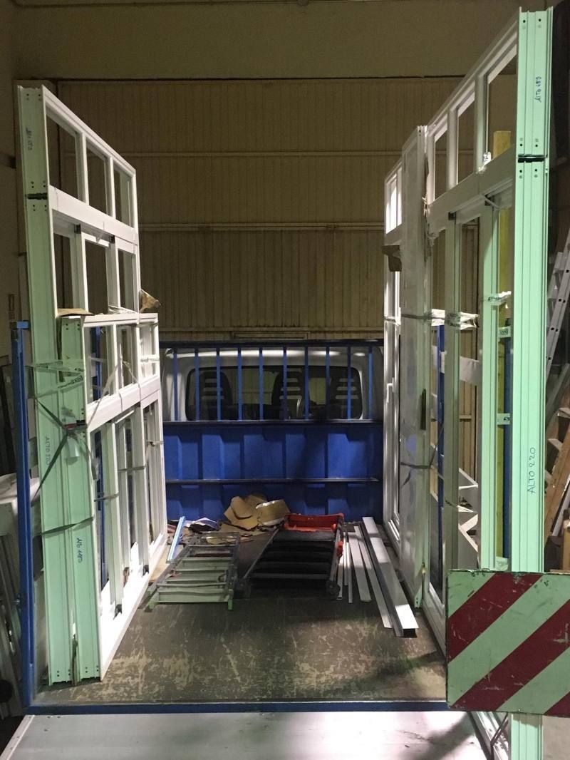 Una habitación con muchas ventanas y una franja roja y blanca en el costado.