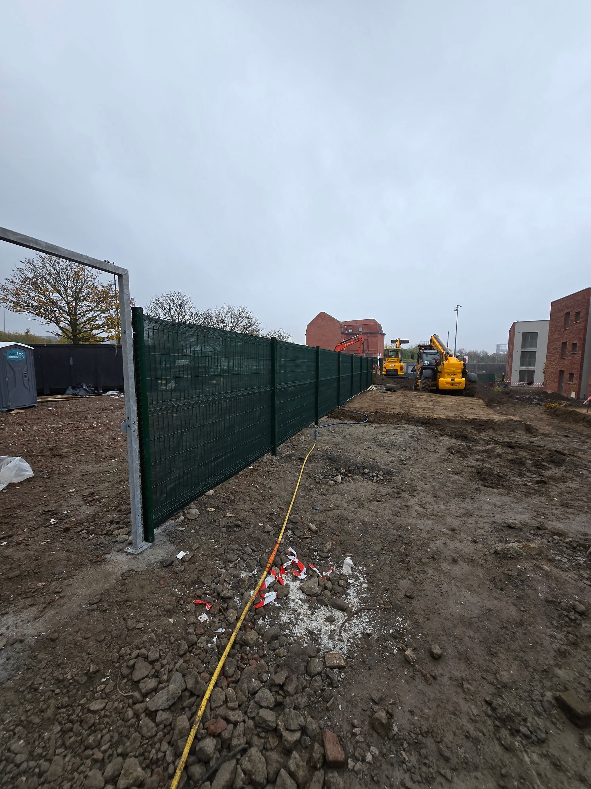 Grillage vert avec portique de limitation de hauteur pour véhicules