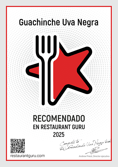 Un cartel que dice guachinche uva negra recomendado en restaurante gurú 2025